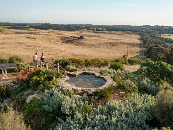 a couple heading towards the thermal pool at Peninsula Hot Springs 