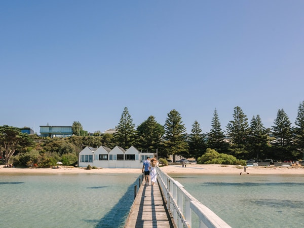 a couple walking along the Sorrento Pier