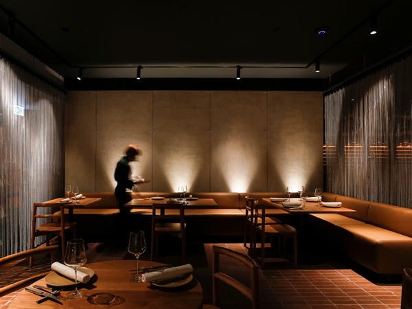 the dimly lit restaurant interior of Aru Restaurant, CBD