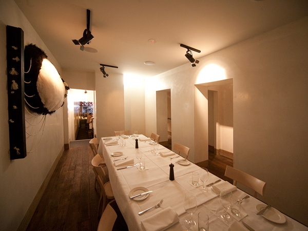 a whitewashed dining interior at Cafe Di Stasio