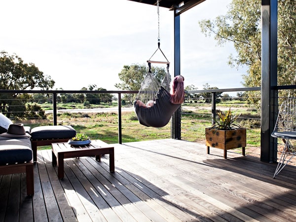 a woman relaxing in a hammock with views across the countryside at Callubri Station, Buddabadah