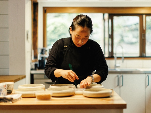 a chef preparing dishes at Chae, Cockatoo