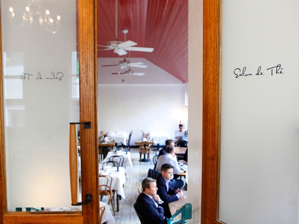 a window showing the inside of the restaurant at French Saloon