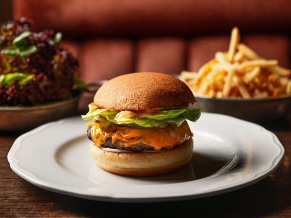 a burger on the plate with fries on the side at Gimlet at Cavendish House