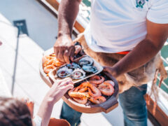 Guest enjoying bush tucker inspired canapes onboard a Saltwater Eco Tour