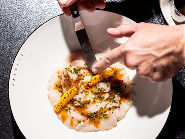 a plating of food topped with herbs and spices at Pascale Bar & Grill, CBD