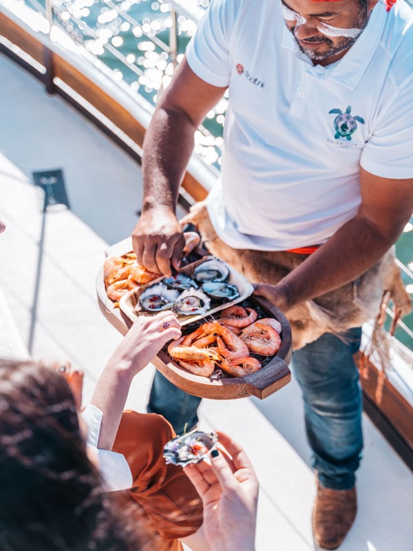 Guest enjoying bush tucker inspired canapes onboard a Saltwater Eco Tour