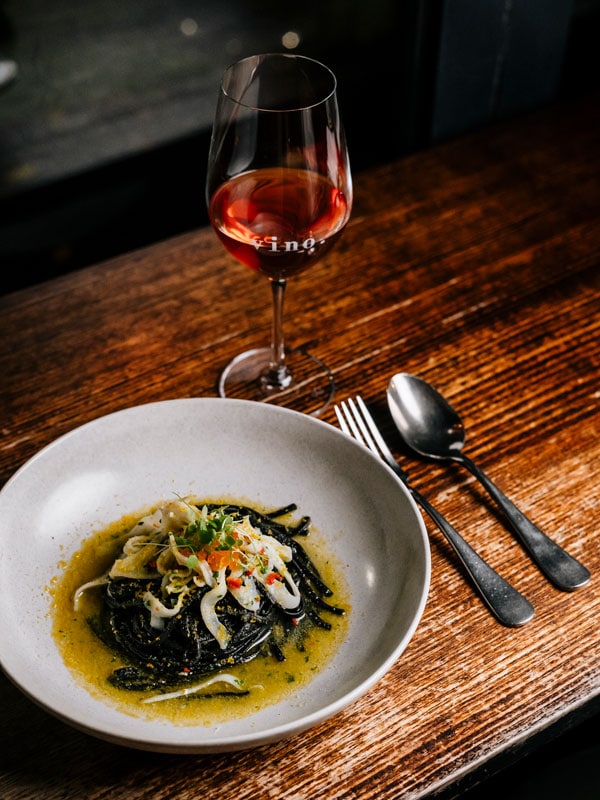 pasta and wine on the table at Tipo 00 restaurant in Melbourne CBD