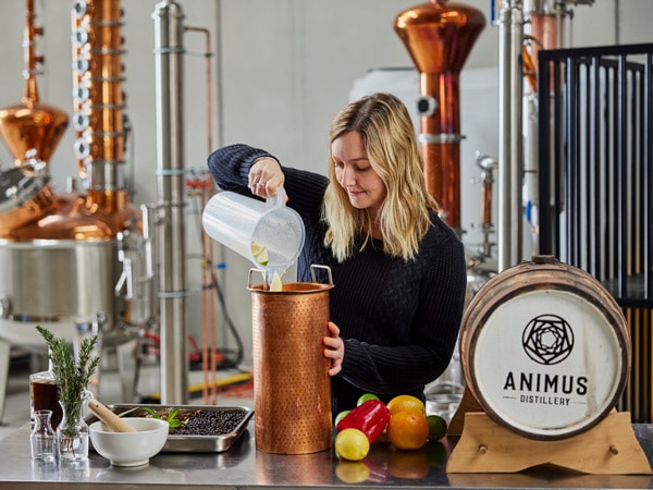 a woman mixing drinks at Animus Distillery, Kyneton