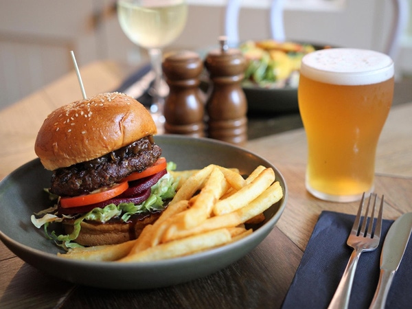 burger with fries and beer on the table at The Fortune of War, The Rocks, Sydney