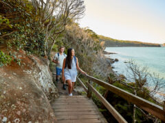 a couple enjoying the walk from Spit Bridge to Manly with scenic views across Sydney Harbour