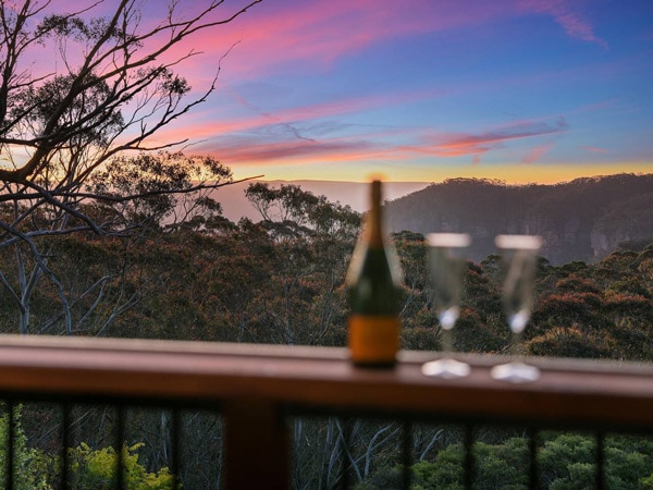 a wine bottle with glasses on the balcony at sunset, Megalong Lookout Cottage