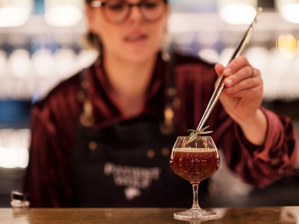 Mixologist serves a cocktail at Patient Wolf in Melbourne