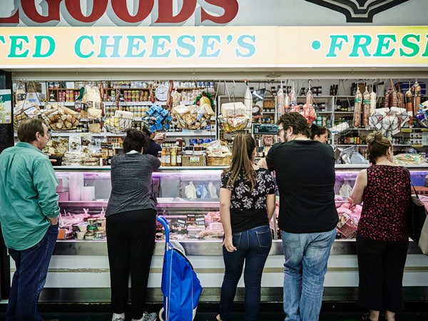 Patrons line up to purchase cheese at Preston Markets