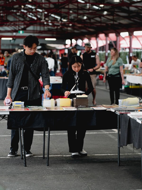 Two people shopping at the Queen Victoria Markets