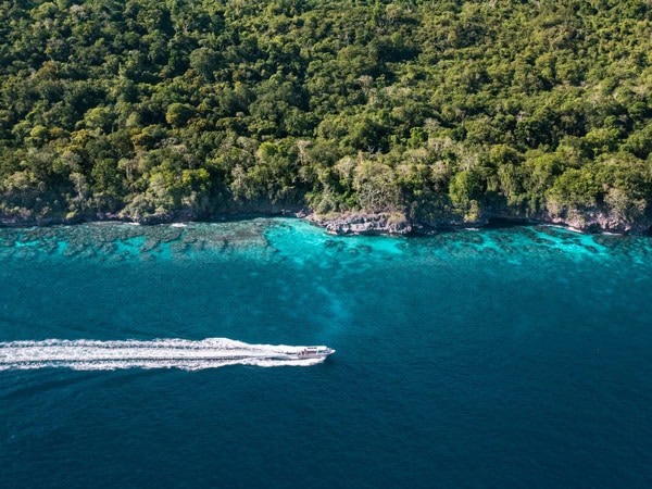 a drone shot of a boat sailing across Christmas Island