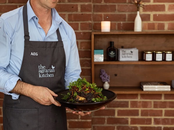 a chef holding a dish at The Agrarian Kitchen, Tas
