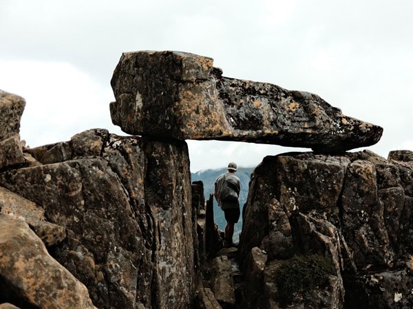 a man standing in the middle of a megalith