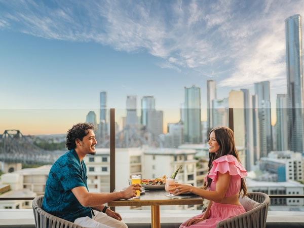 a couple dining at Iris Rooftop