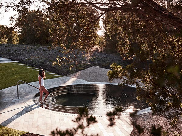 woman getting into a pool at Alba Thermal Springs