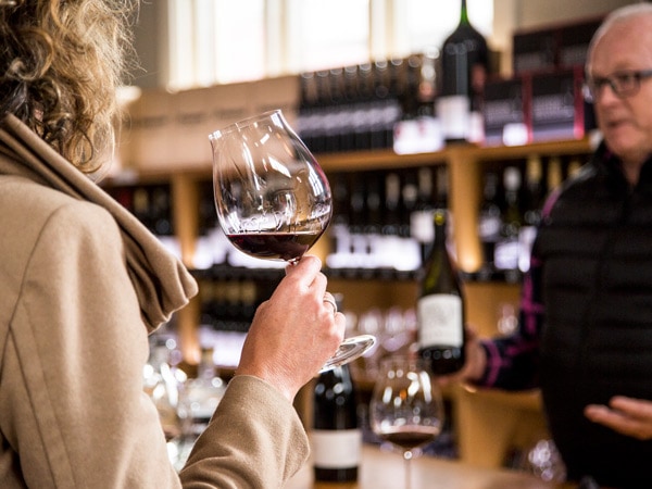 a woman holding a glass of wine at Ferment the Orange Wine Centre