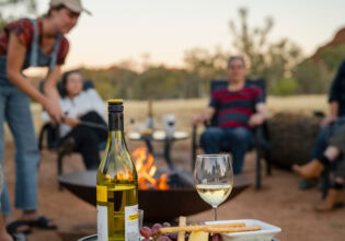 Family around the campfire at Squeaky Windmill near Alice Springs