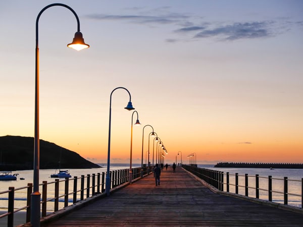 sun rises over the pier at Jetty Beach, Coffs Harbour.