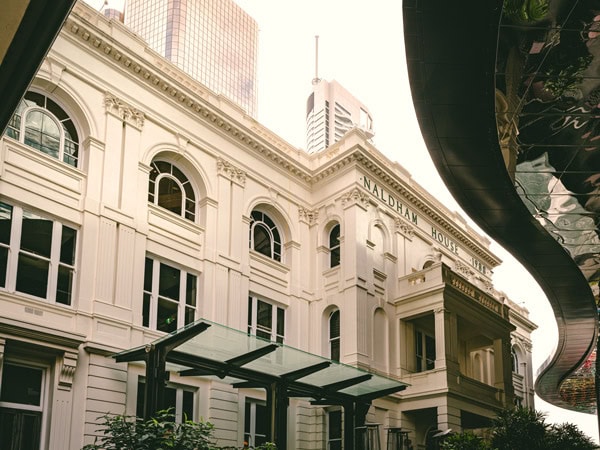 the white-washed heritage building exterior of Naldham House, Brisbane