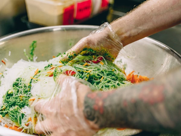 mixing a salad bowl at The Happy Frog, Coffs Harbour
