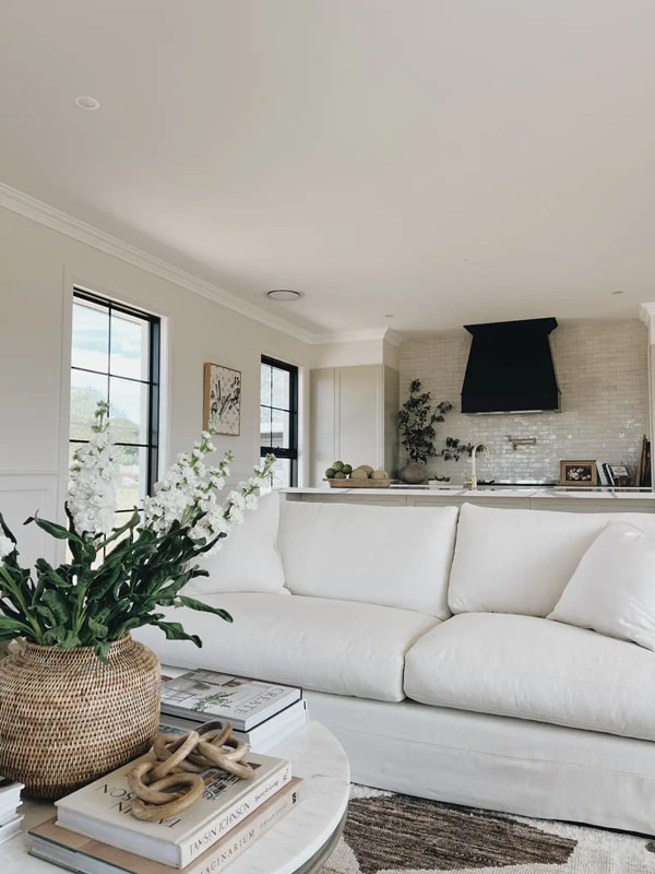 the white-washed living room interior at Shinglewood Cottage