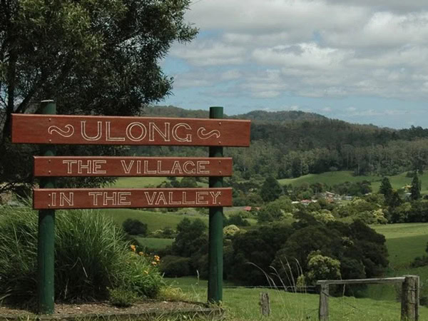 Ulong the Village in the Valley signage with lush greenery in the background