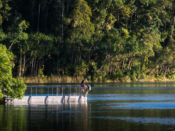 Two people swimming in Lake Eacham