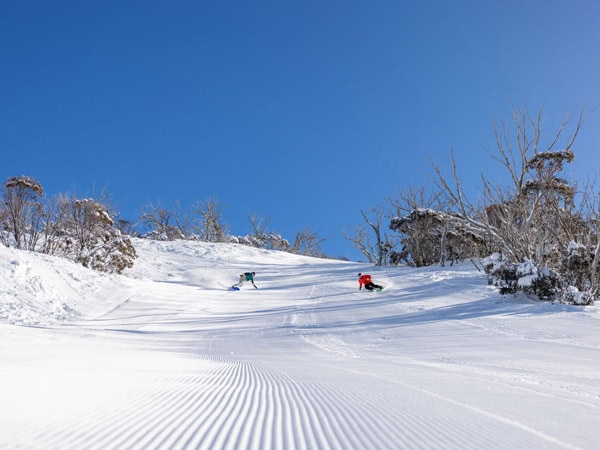 A skier and a snowboarder at Thredbo