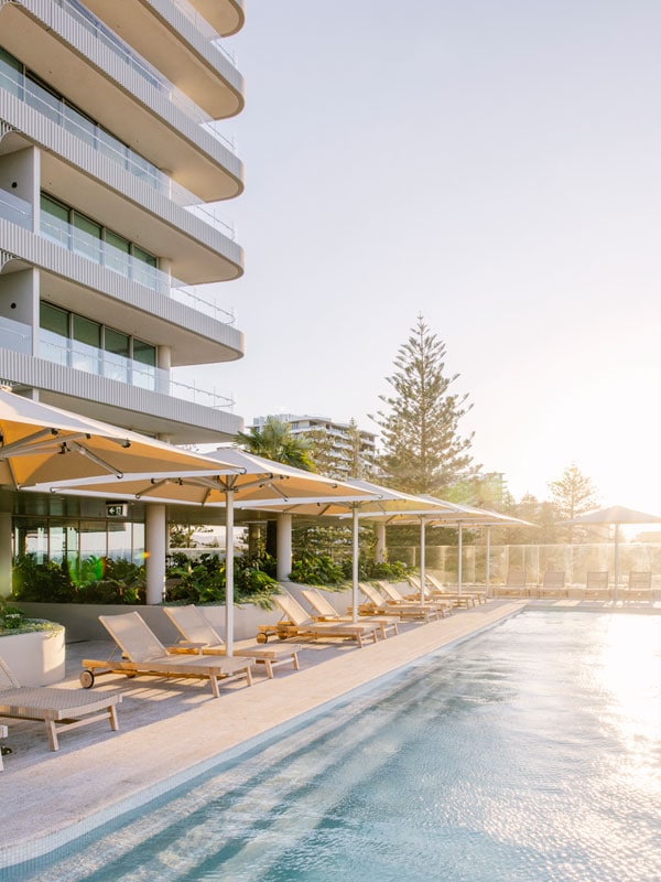 the outdoor pool at Kirra Point with sunloungers on the side