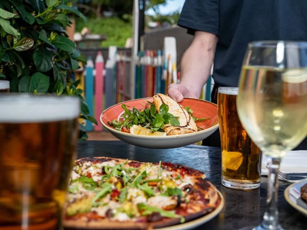 a close-up of pizza and drinks on the table