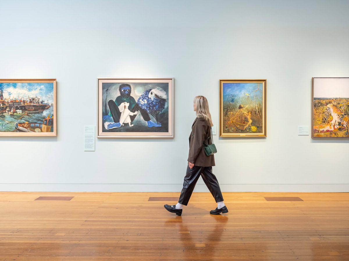 Woman admires artworks at Bendigo Art Gallery