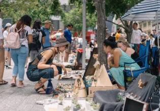 People crouching at Brisbane Suitcase Rummage