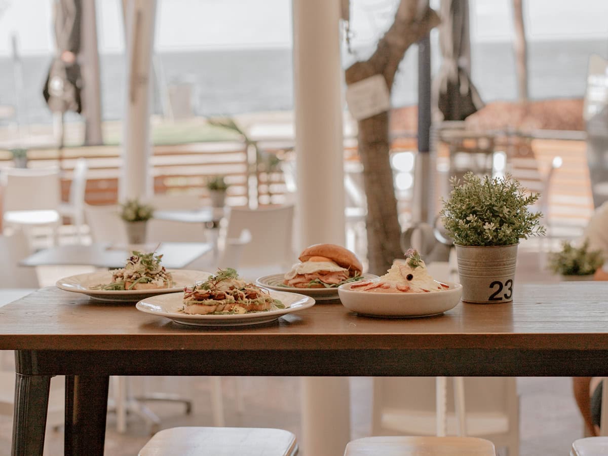 Views of the beach and food at De Ja Vu Cafe & Bar