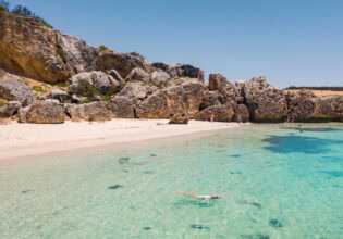 the white-sand shoreline and crystal clear waters of Stokes Bay