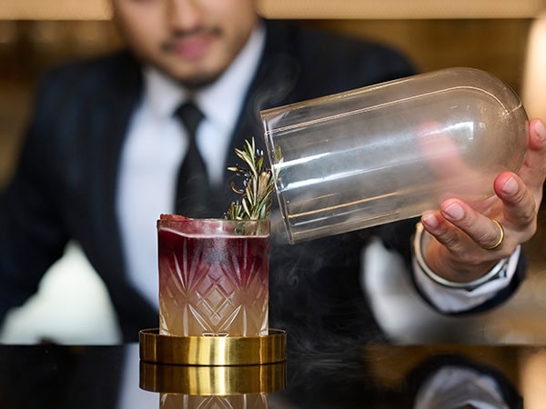 bartender maing smokey cocktail at Hyatt Hotel Canberra