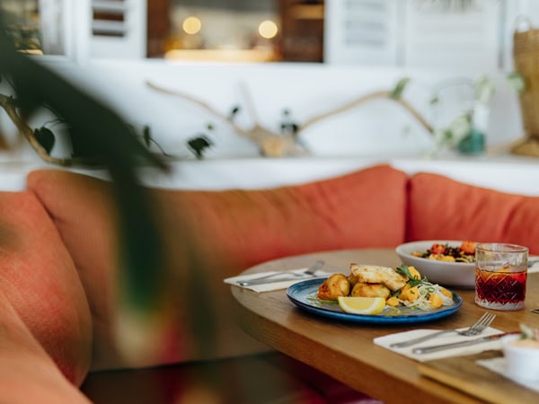 cosy seating with food on the table inside Jetty Beach House