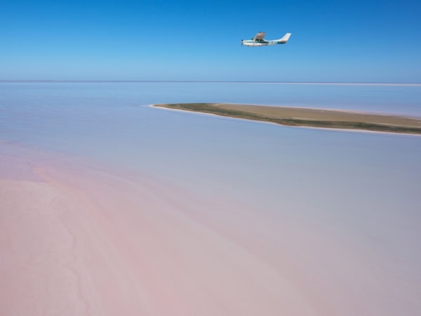 a plane flying over Kati Thanda-Lake Eyre, SA