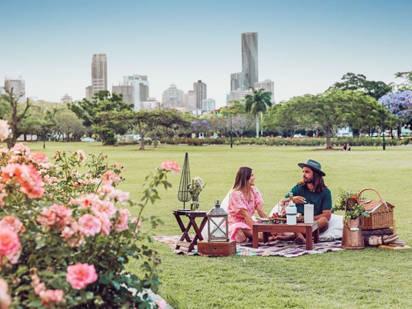 Couple picnic in New Farm Park near Howard Smith Wharves