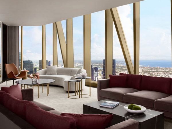 the elegant interior of the Ritz-Carlton Suite with floor-to-ceiling windows and views over the city