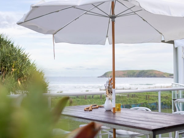 an al fresco dining with umbrella facing the sea at Donovan’s Surf Club Restaurant and Bar