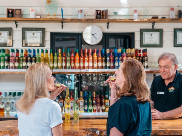 two women drinking shots at Tamborine Mountain Distillery