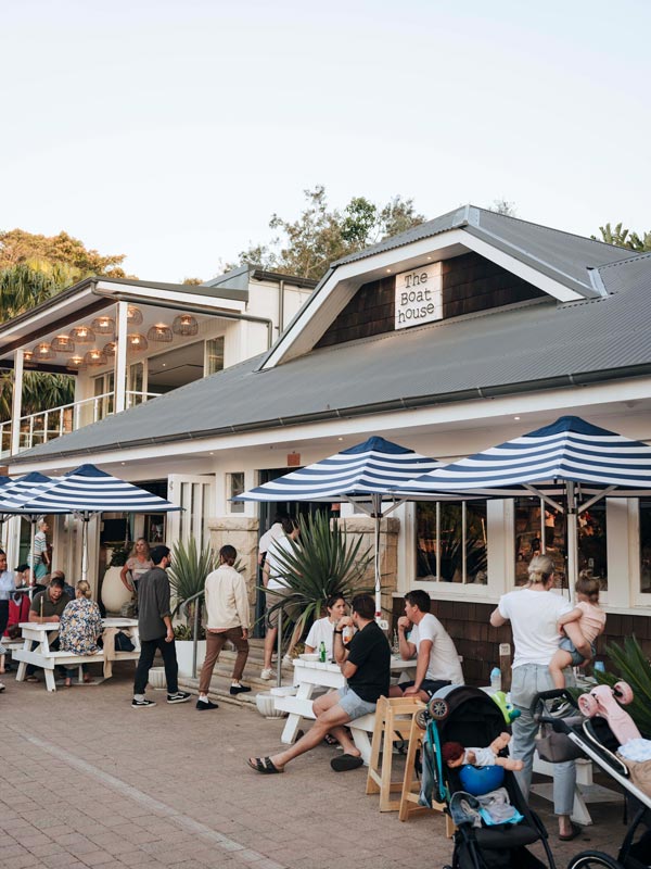 people sitting outside The Boathouse on Shelly Beach