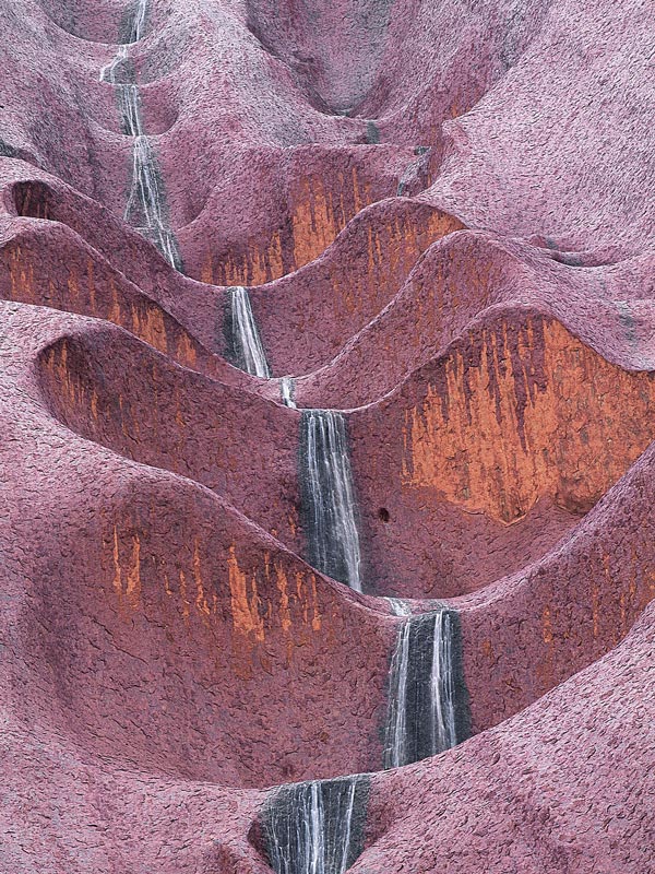 the Uluru Waterfalls cascading down the purple rocks