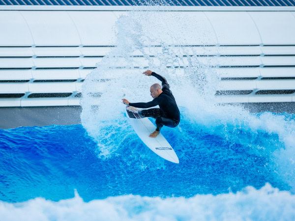 a surfer riding a huge wave at URBNSURF Sydney