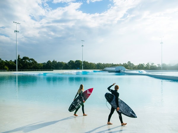 two surfers holding surfboards at URBNSURF Sydney